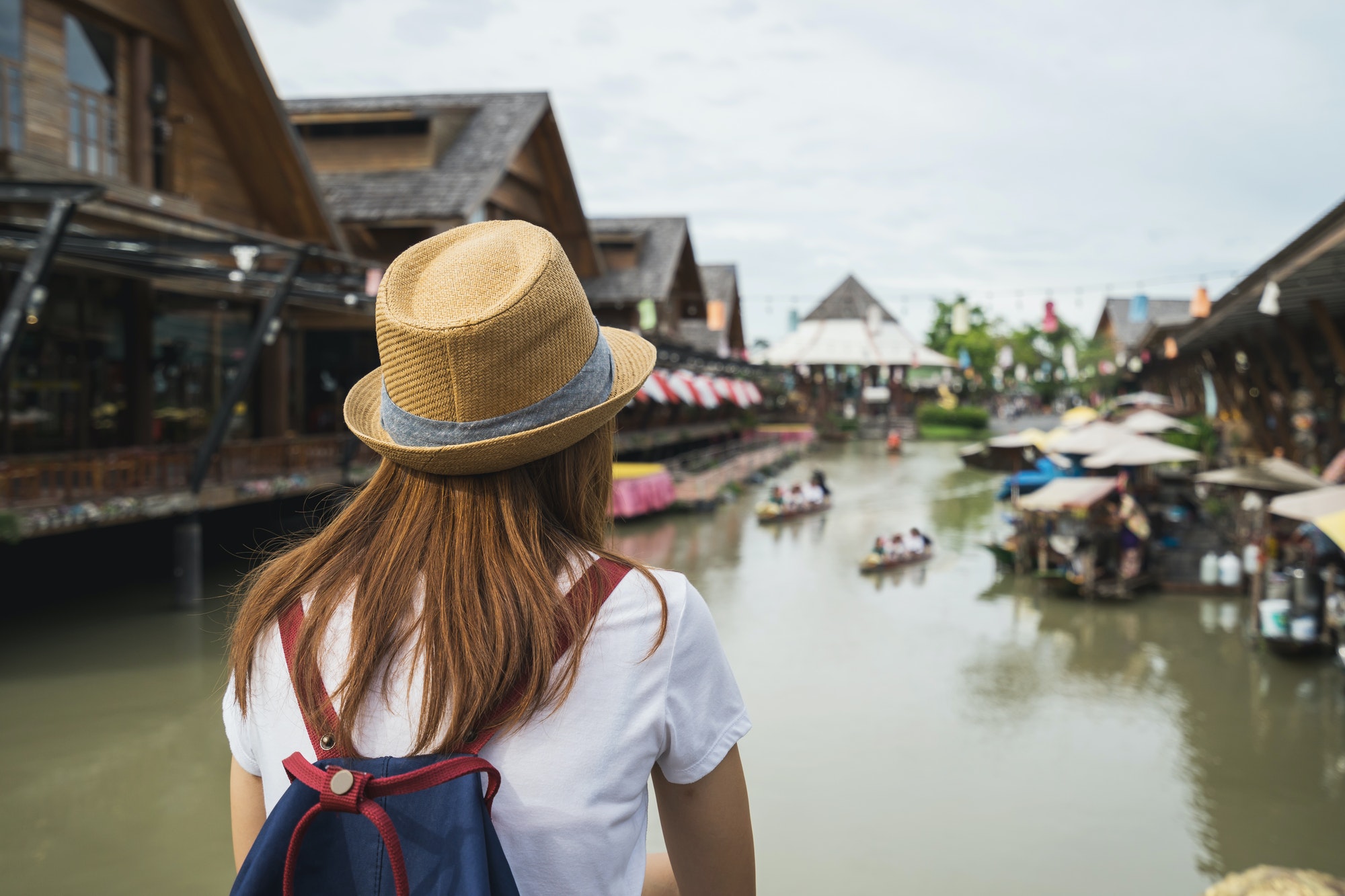 Young woman travel at floating market in Thailand